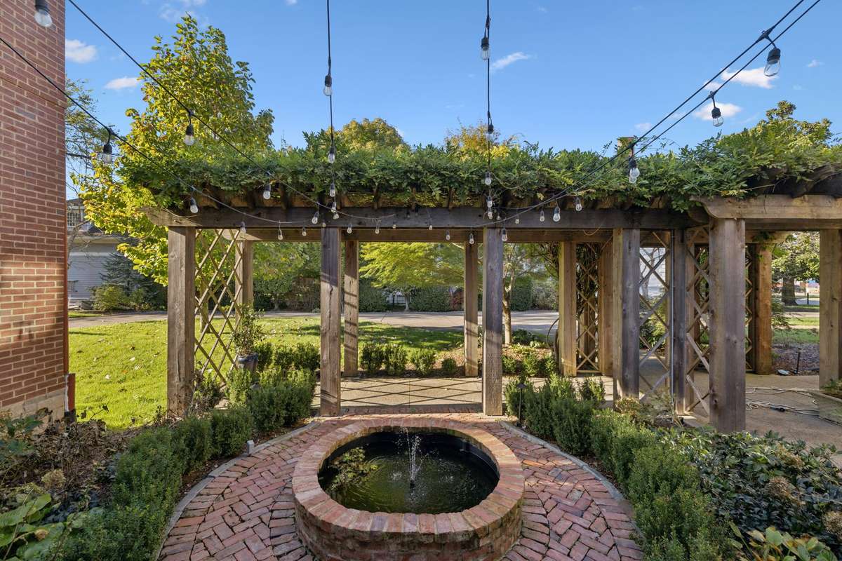 The addition of a new trellis and the renovation of the fountain area beautifully enhance the native plantings.