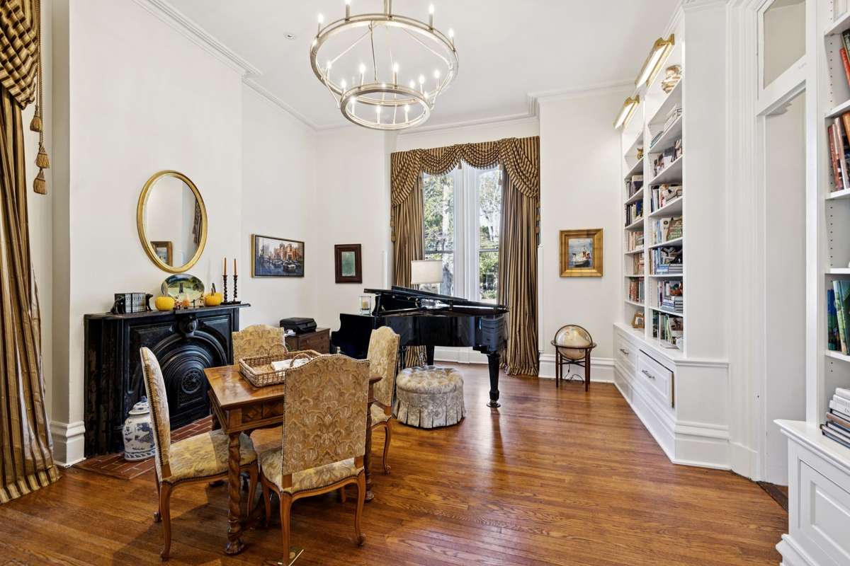 The library is highlighted by exquisite, custom-built bookcases.