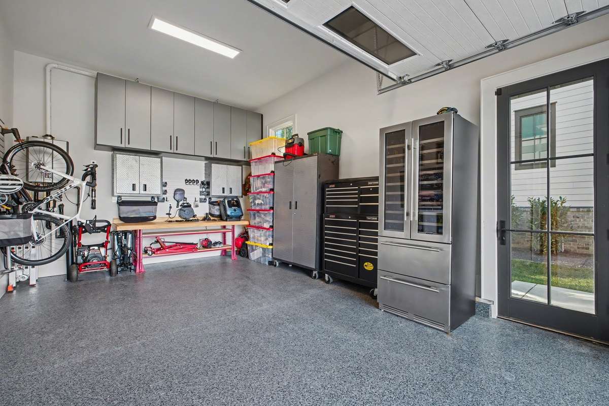 Separate Single Car garage with Walk-out Door and the same Custom Storage Cabinetry & Epoxy Finished Floor