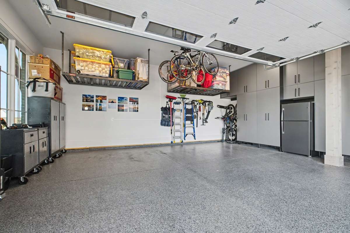 Amazing 2 Car Garage with Epoxy Finished Flooring and Extensive Custom Storage/Cabinetry AND Overhead Storage Areas