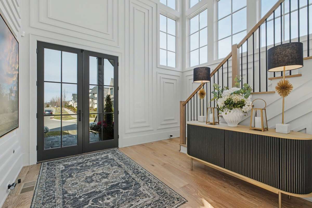 Entry Area with 2 Story Wall of Windows flooding the space with Natural Light - Another View of the Intricate Millwork