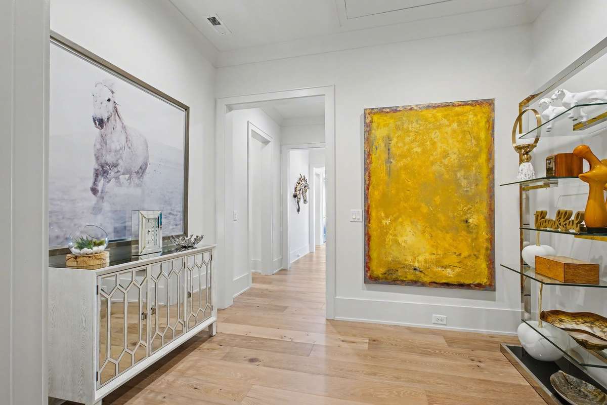 Hallway in the Upper Level leads to a Half Bath and Bonus & Exercise Room/Office