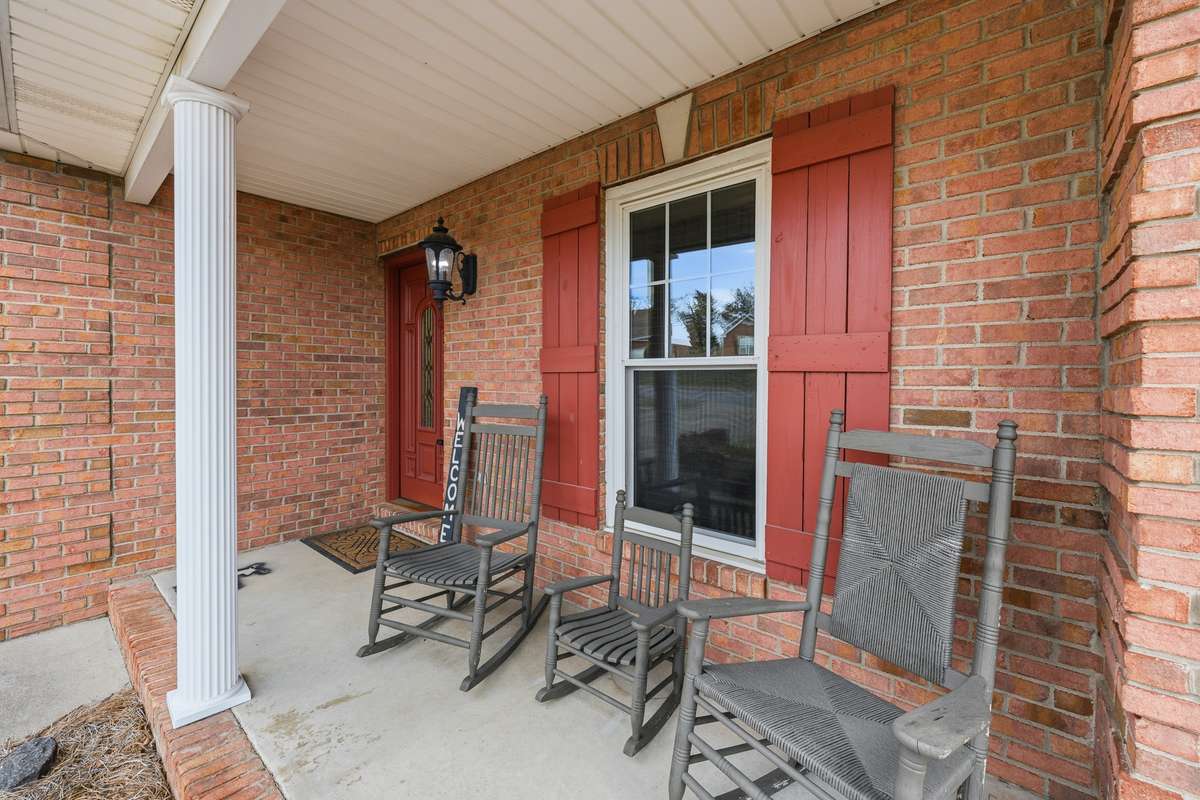 Rocking Chair front porch.  (Be sure to scroll to the end for more exterior and drone photos!  The rear deck is awesome!)