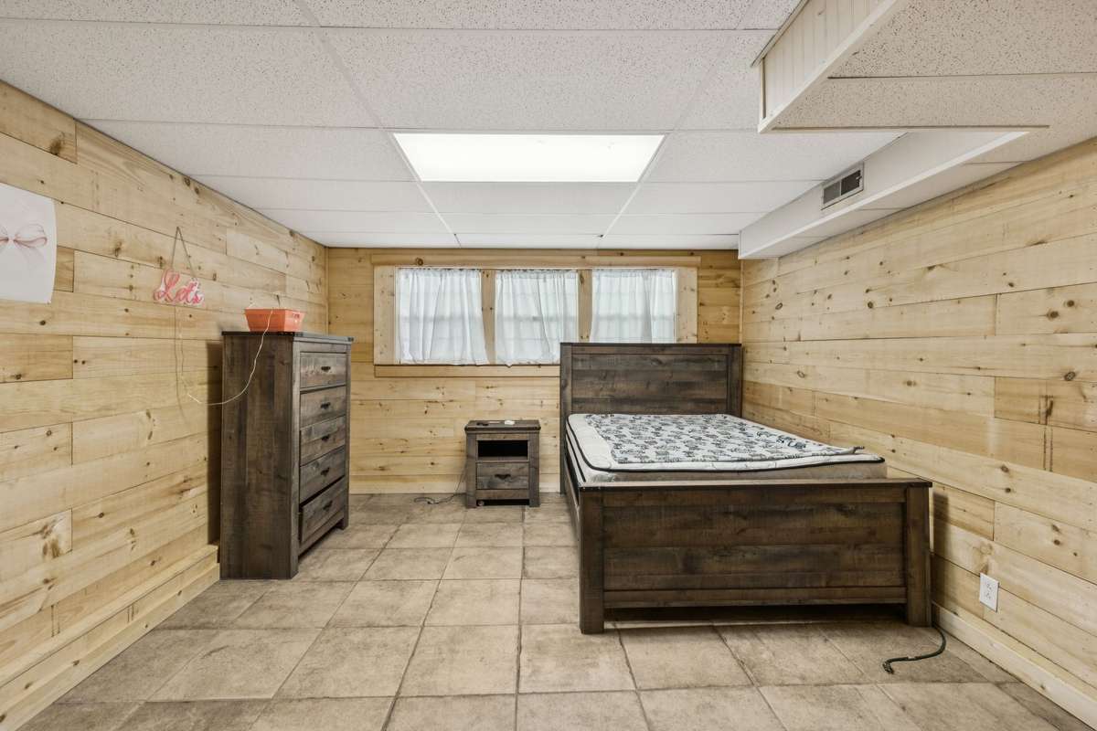 Bedroom in basement with furniture