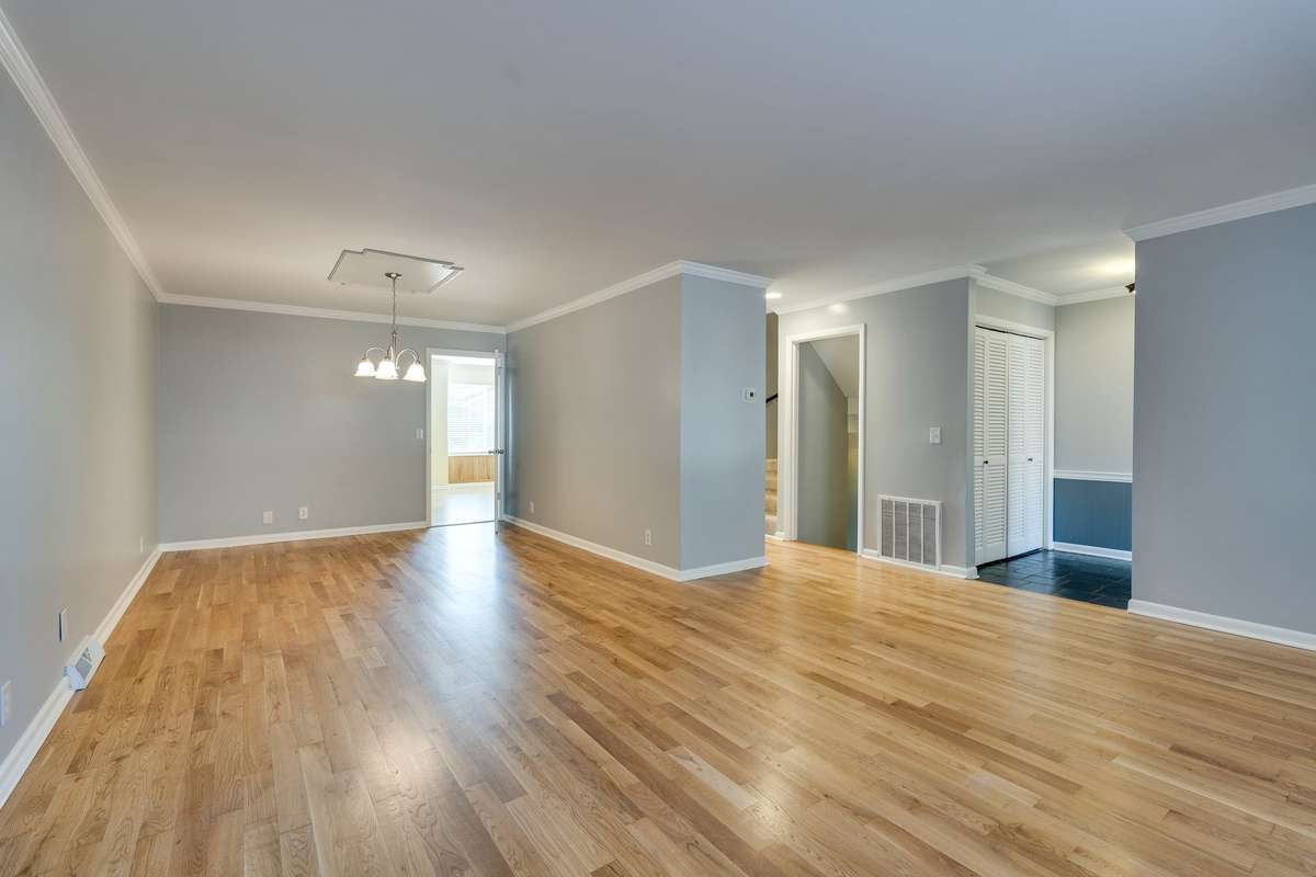 Living room, dining room combo with real hardwood flooring.