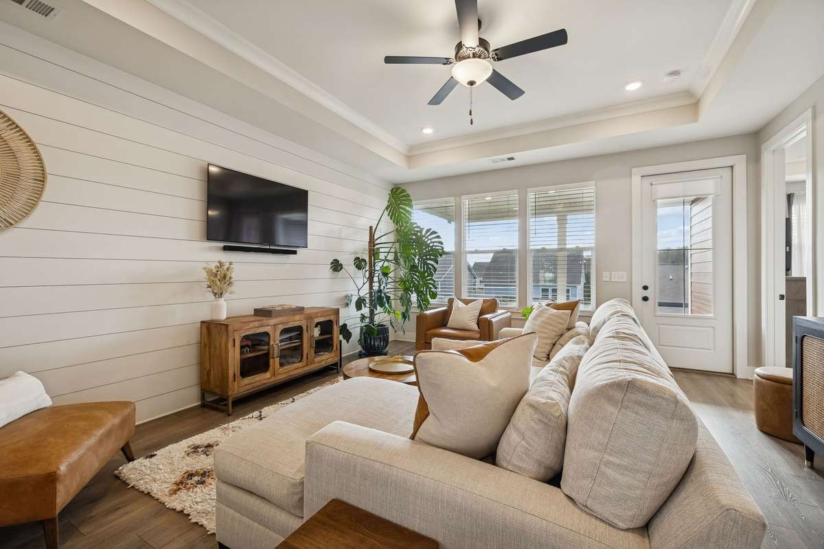 Sun drenched living room with shiplap accent wall.