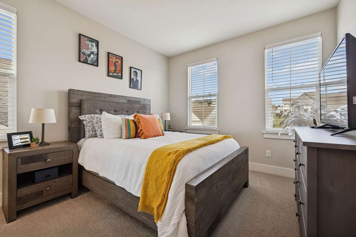 Upstairs guest bedroom boasts 3 windows and a walk in closet.