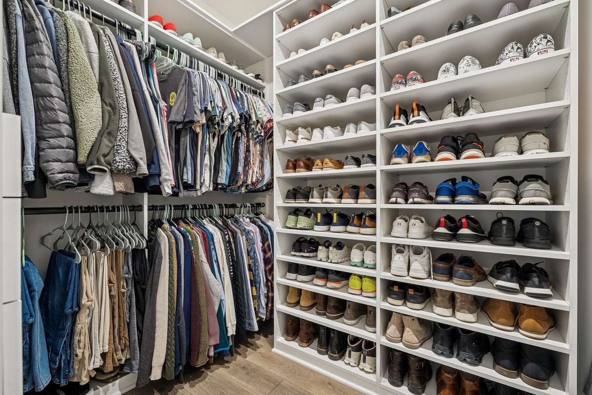 Custom primary closet is fully customizable. Rods can be removed for hanging longer garments or add additional open shelves.