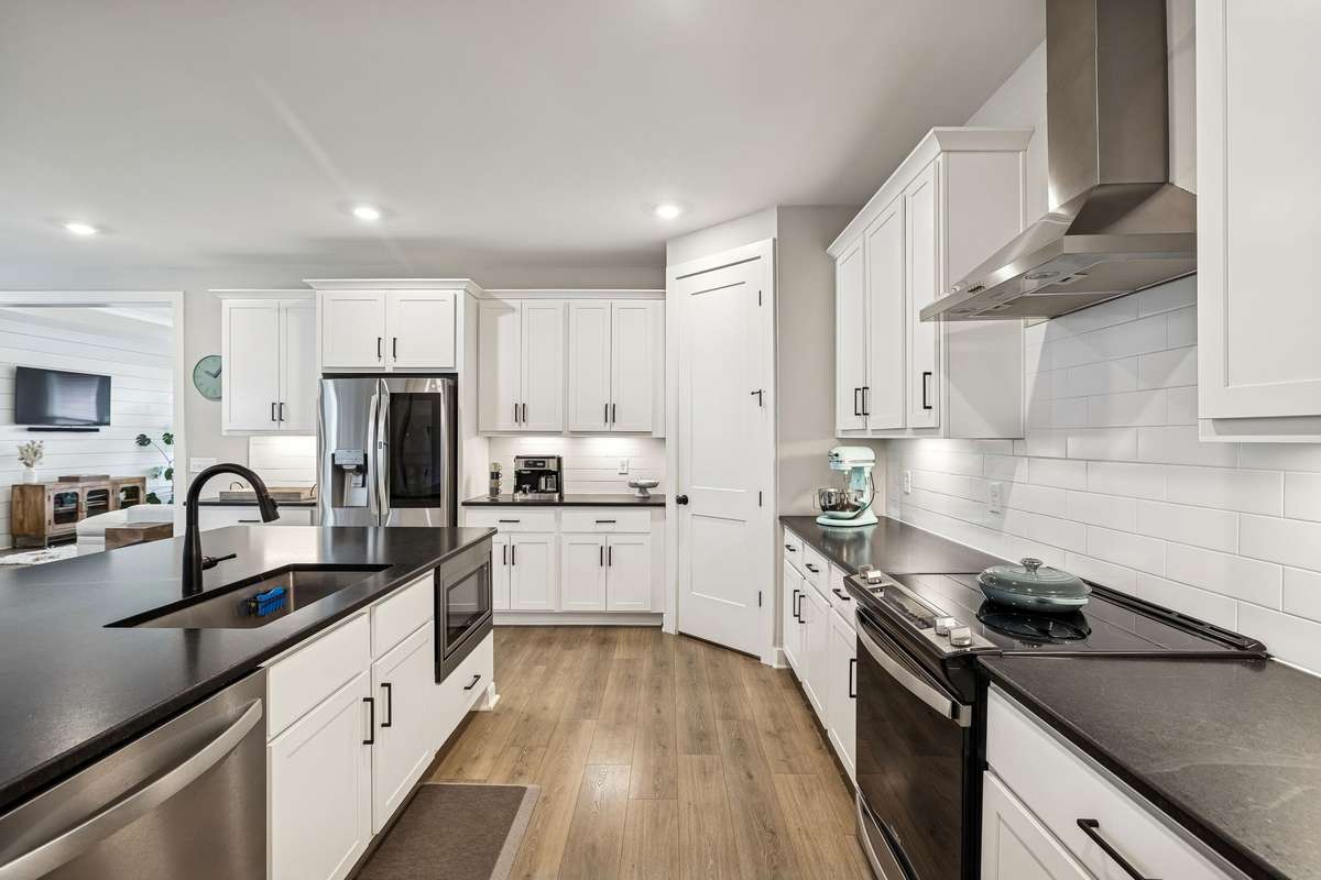 Ample cabinet space for storage and microwave tucked into the island.