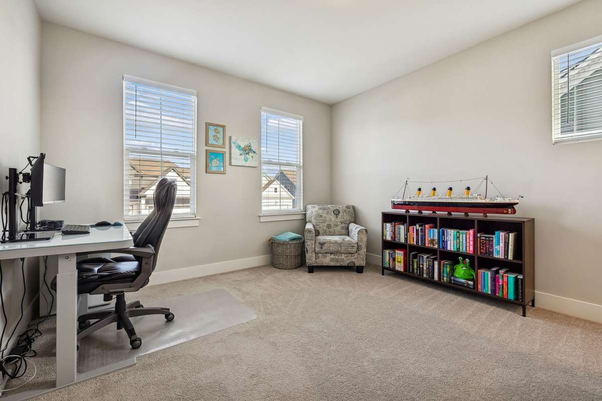 Second guest room, currently being used as an office, has ample natural light and plenty of space for a bedroom, office, workout room, crafting area, or anything you need.