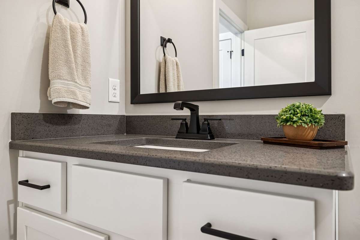 Guest bathroom vanity is classic and spacious.