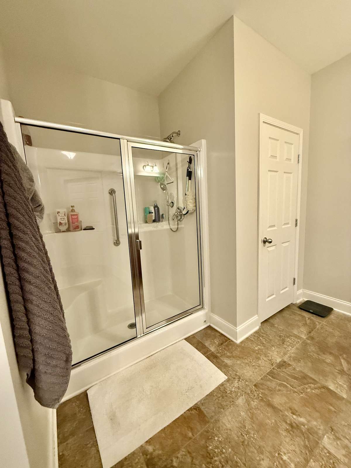oversized Primary Suite overlooking the expansive backyard, complete with a walk-in shower, separate double vanities, and double closets.