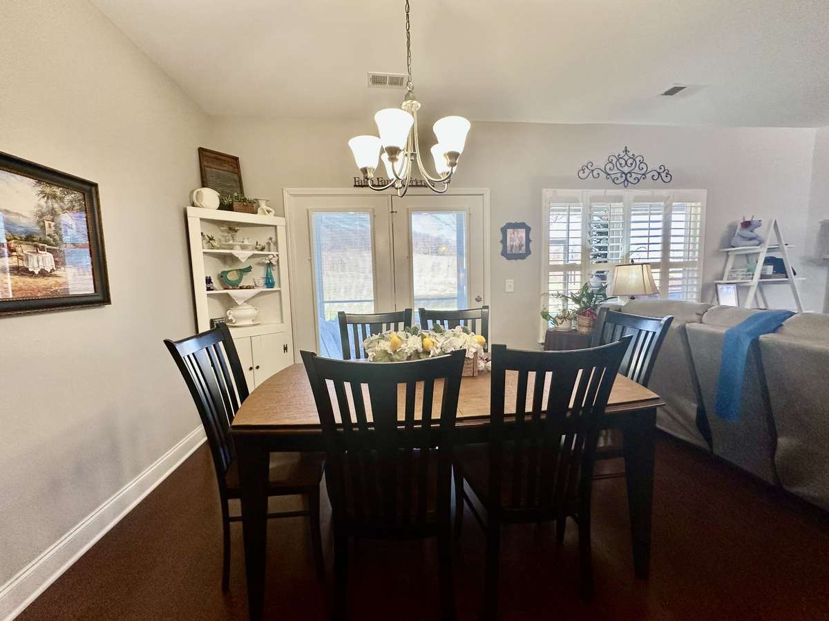 Large Eat in area looking over screened patio and spacious backyard