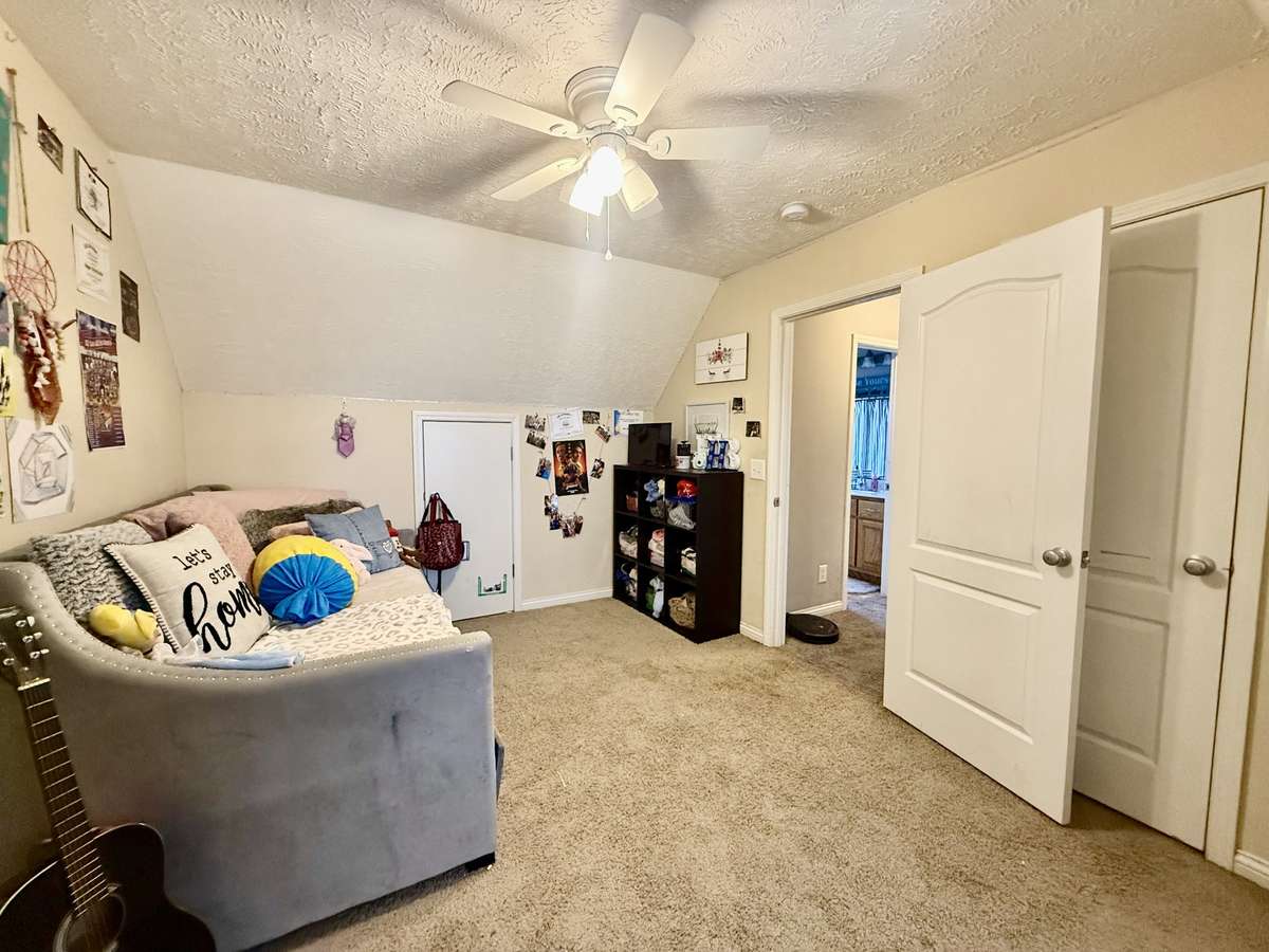 Upstairs Bedroom #3 with large closet; ceiling fan, carpet; knook area for sitting or study area