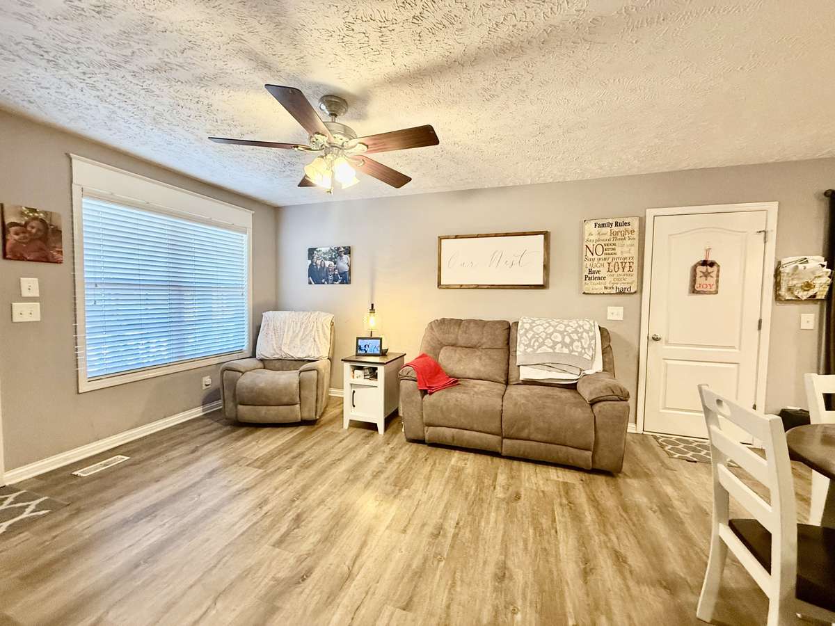 Large Living Room with laminate flooring, with ceiling fan, flows into the Kitchen, enter Living Room from the 1 car garage or the front door; Great area for family gatherings