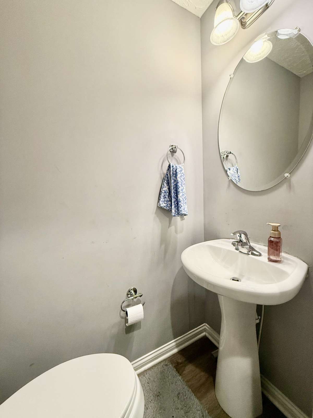 Half Bath with Pedestal sink with laminate flooring