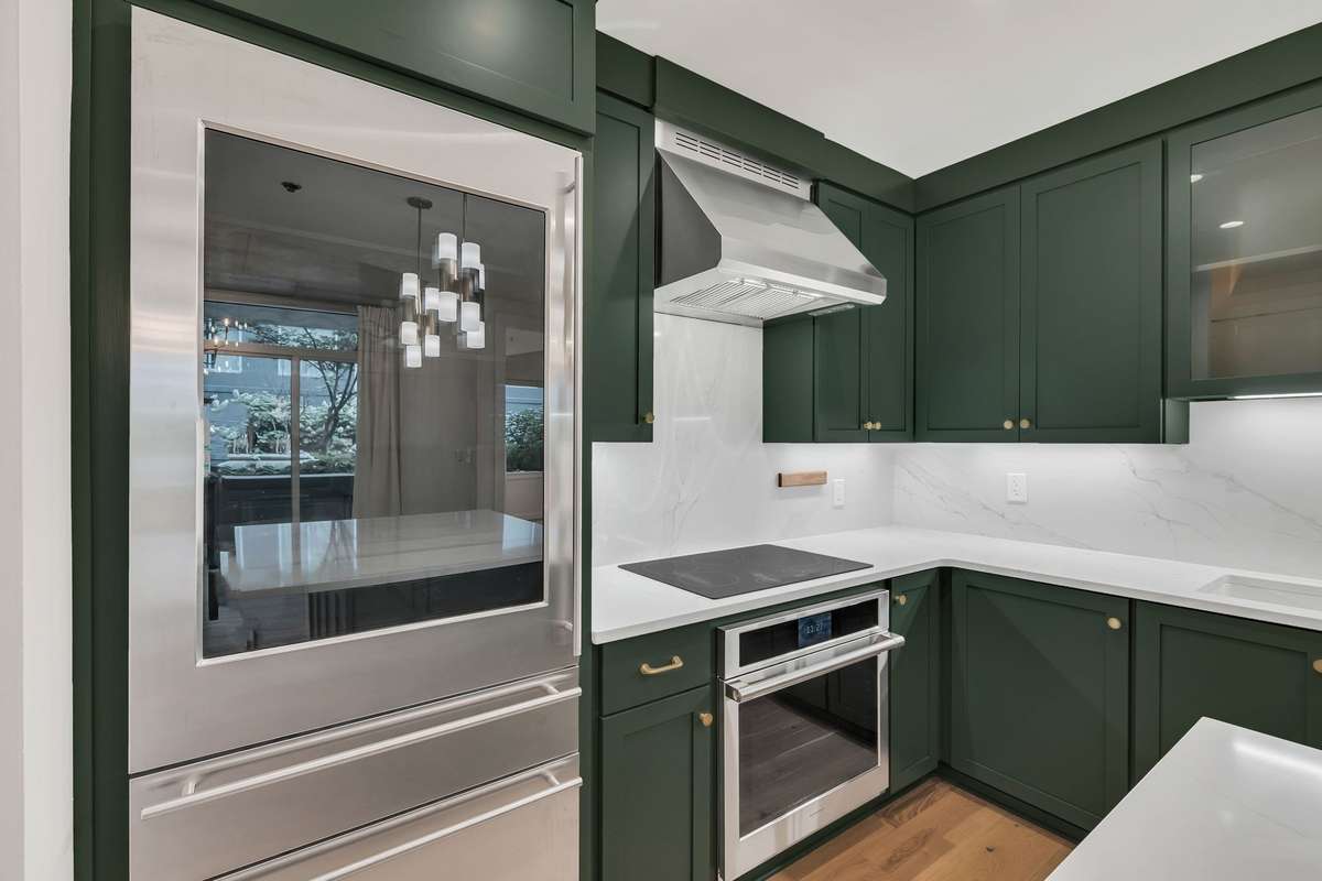 GE Monogram appliances, new vent hood, countertops and backsplash, with custom cabinets and new pulls