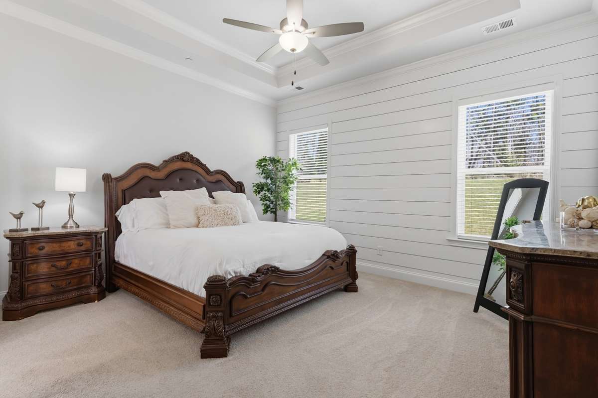 Primary suite is on the main level.  Custom accent wall and tray ceiling.