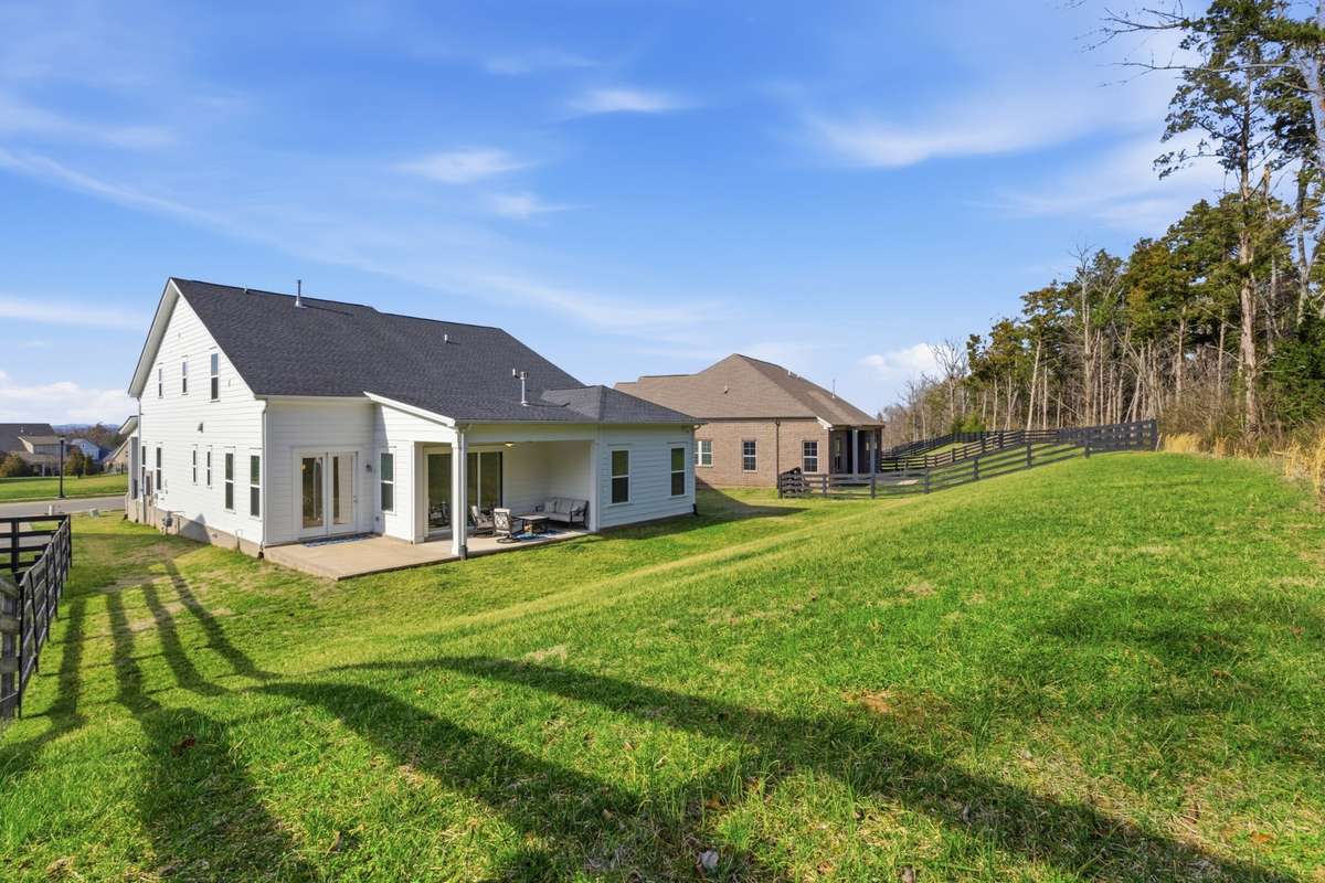 Private tree line behind house.  Enjoy the sounds of nature from the covered back porch.