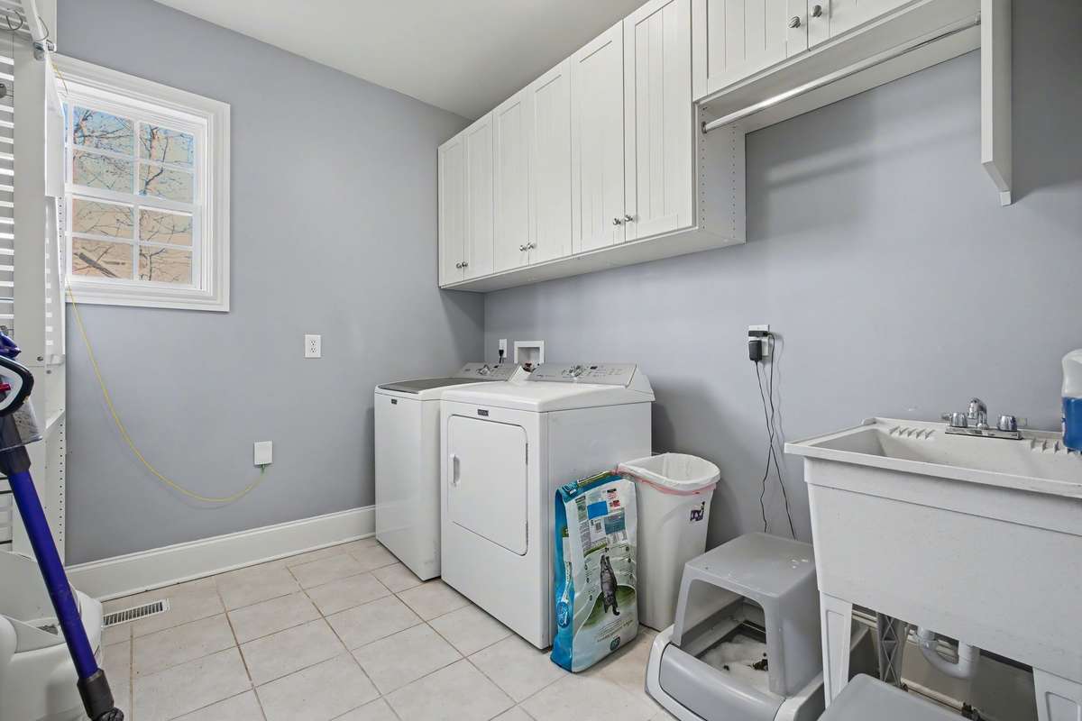 Everyone loves a large Laundry Room with cabinets and a deep sink!!