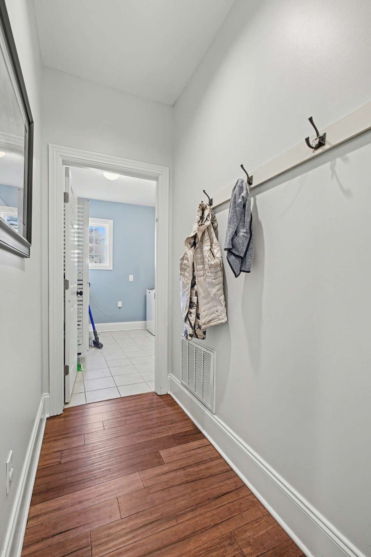 Hallway to Laundry room provides coat or backpack hooks!
