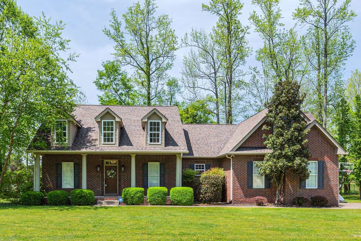 Springtime photo shows off the home nestled in the beautiful mature trees!