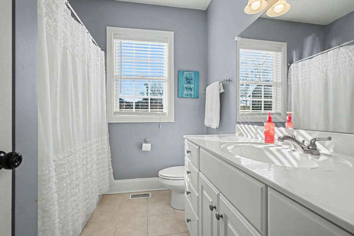 Additional Bathroom between both secondary bedrooms. Tile floors!