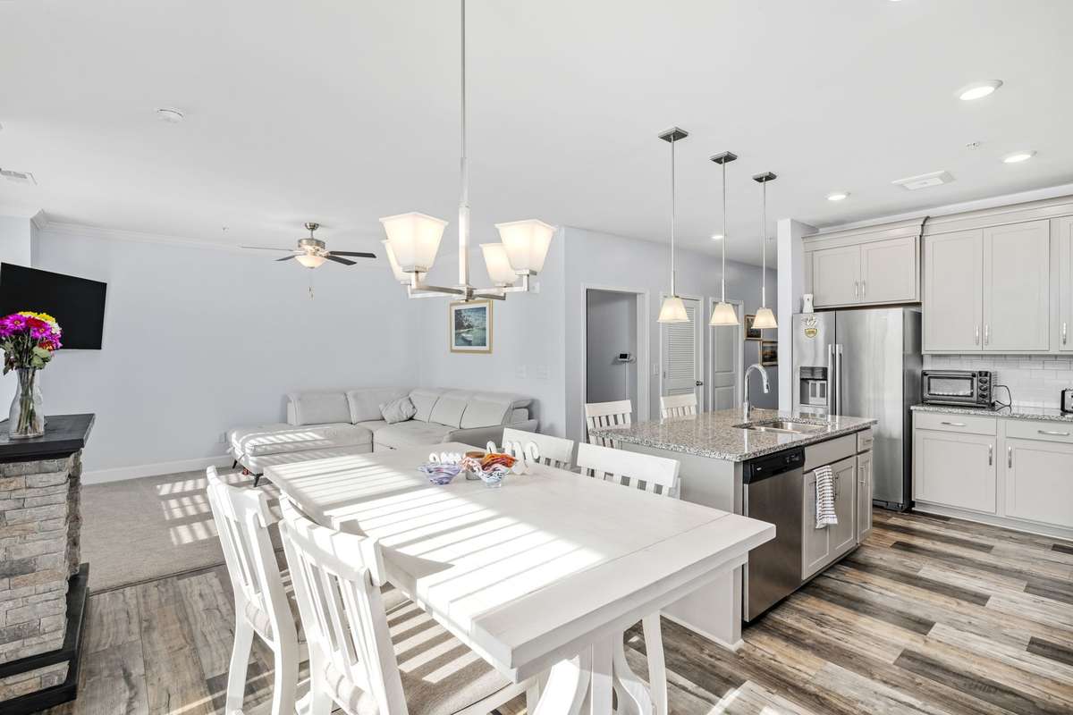 Bright open-concept living and dining space featuring neutral tones that create a clean, modern feel. Light finishes and natural light make the home feel spacious, warm, and inviting.