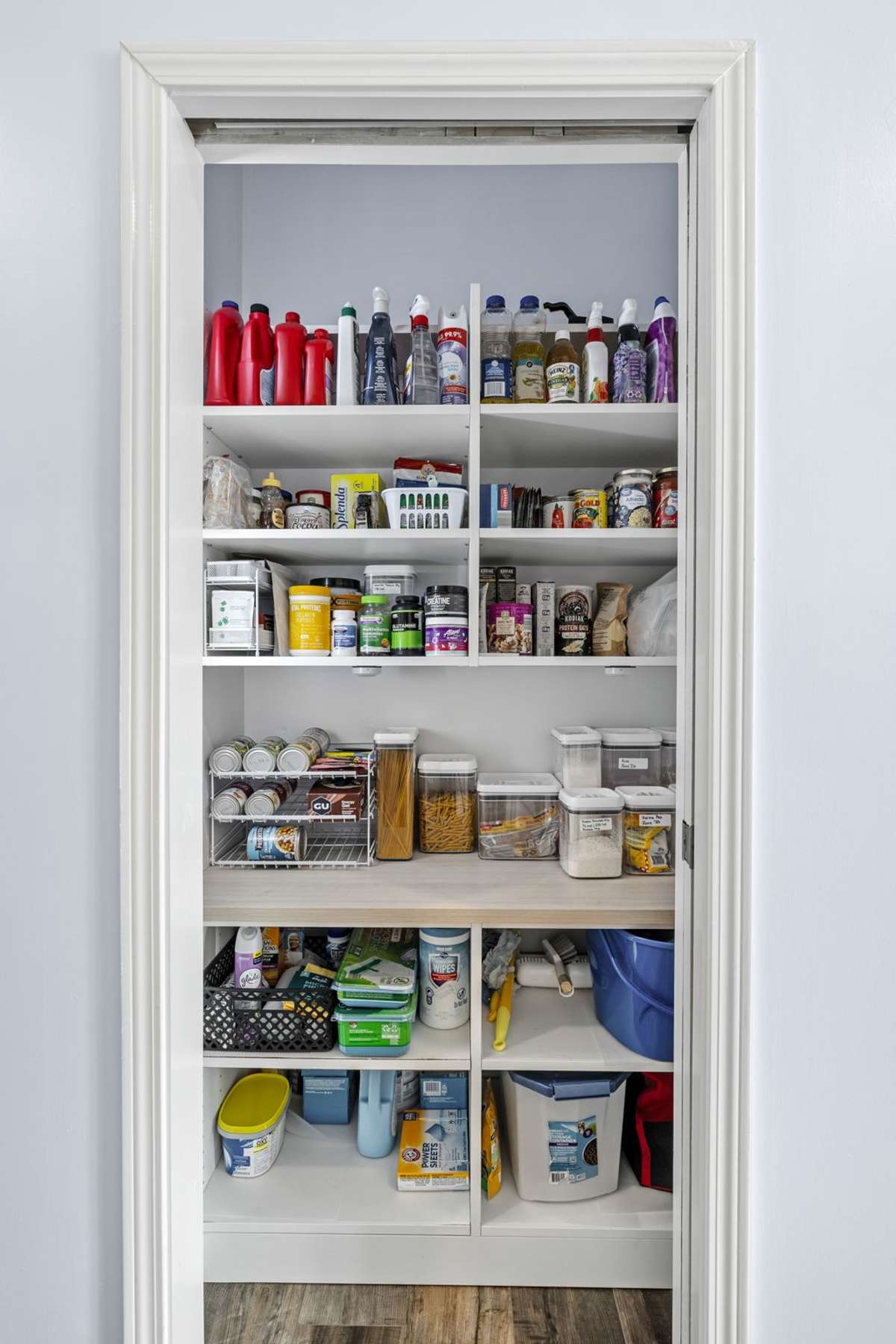 Custom pantry designed by California Closets offers exceptional storage with built-in shelving and thoughtful organization. A stylish and functional space that keeps everything neatly arranged and easily accessible.