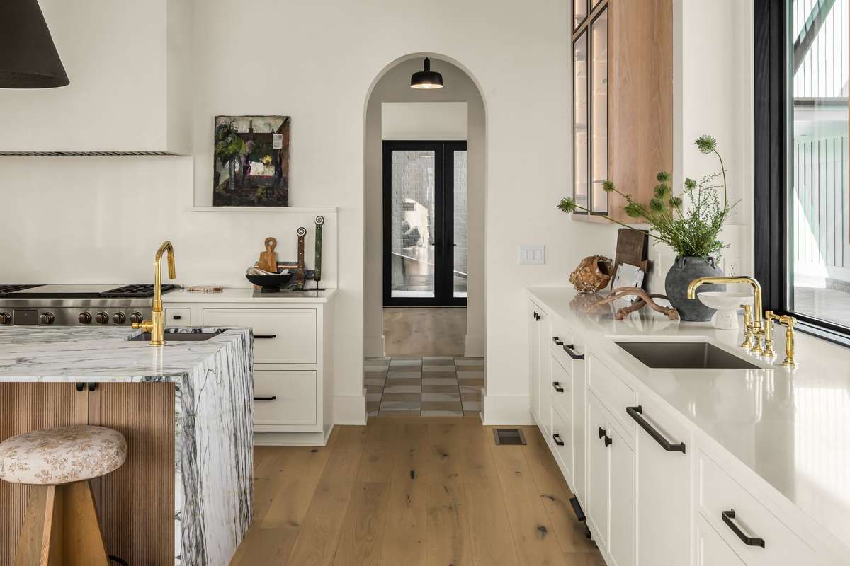 Arched entry leading to the scullery and secondary prep kitchen, offering additional workspace, storage, and a seamless extension of the main kitchen design.