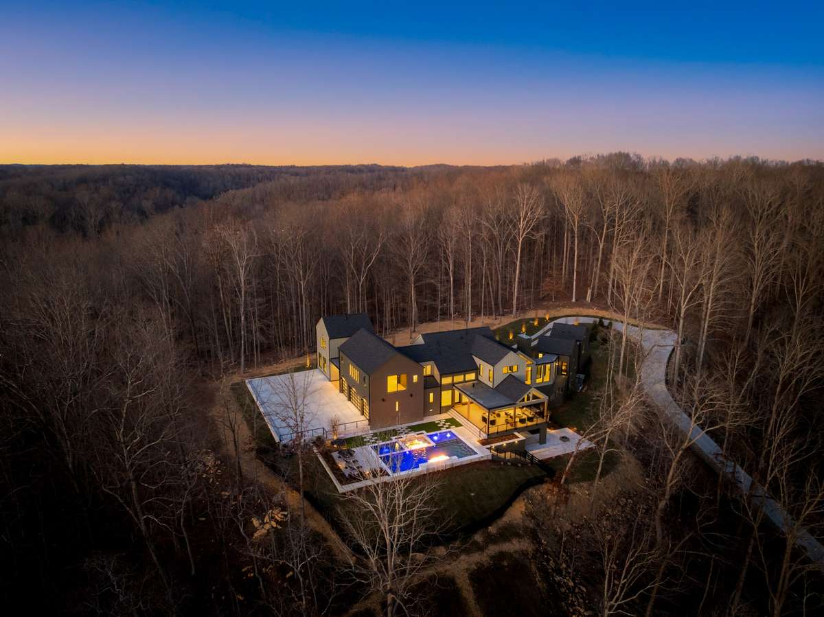 Aerial view of Hill House Estate set atop nearly 10 private acres, offering exceptional privacy, a dramatic hilltop setting, and expansive views across the surrounding Franklin landscape.