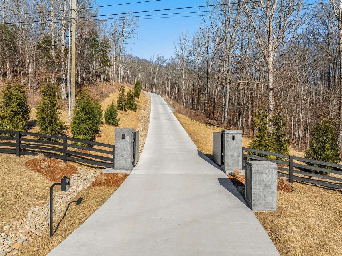Private gated entry leading to the Hill House Estate, offering a secluded approach and a sense of arrival that sets the tone for the exceptional residence beyond.
