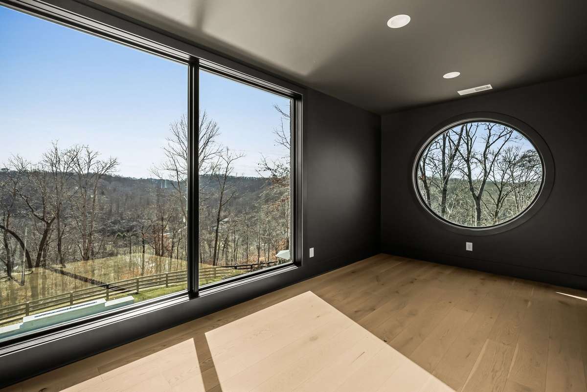 A light-filled upstairs flex space offering endless possibilities for work, play, or relaxation.