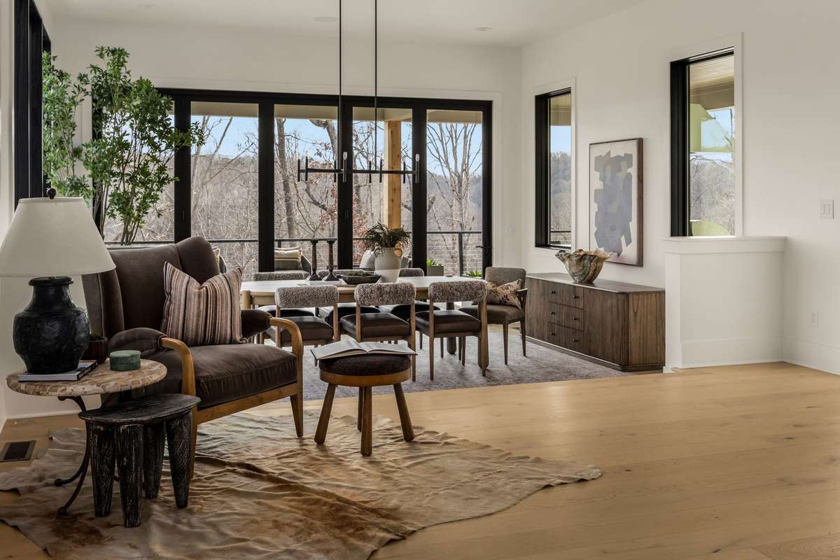 Dining area positioned just off the main living space, featuring expansive glass doors, abundant natural light, and seamless access to the outdoor terrace for effortless entertaining.
