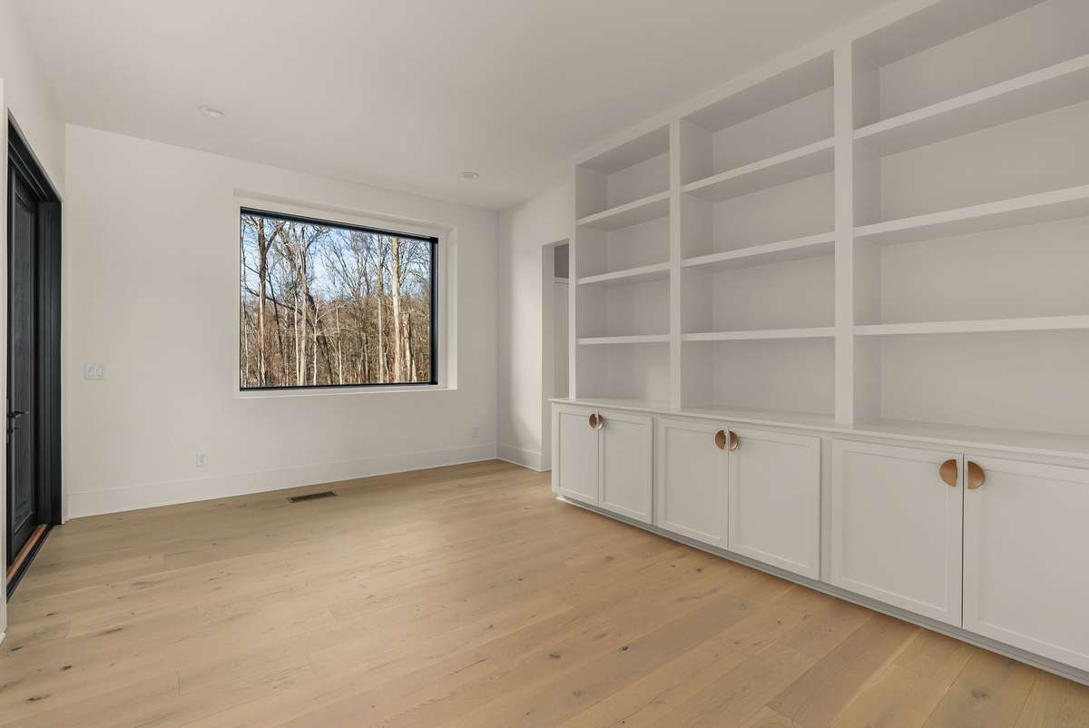 Tucked just off the kitchen, this flexible space easily transforms from functional storage to a private dining room.