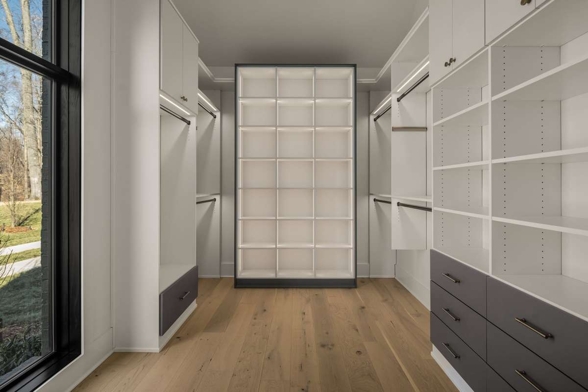 A spacious primary closet designed with custom storage and thoughtful organization throughout.
