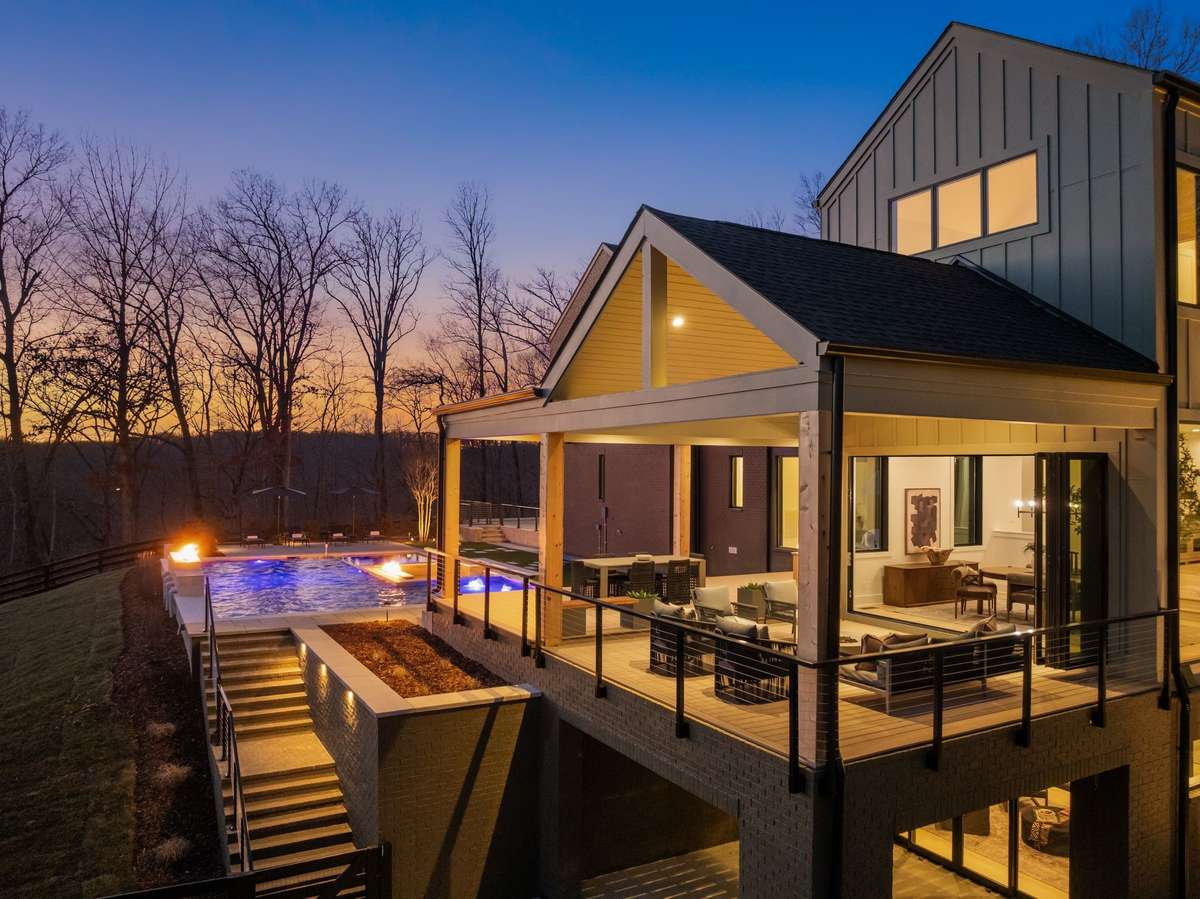 Evenings unfold across covered terraces, fire features, and a heated pool designed for year-round enjoyment.