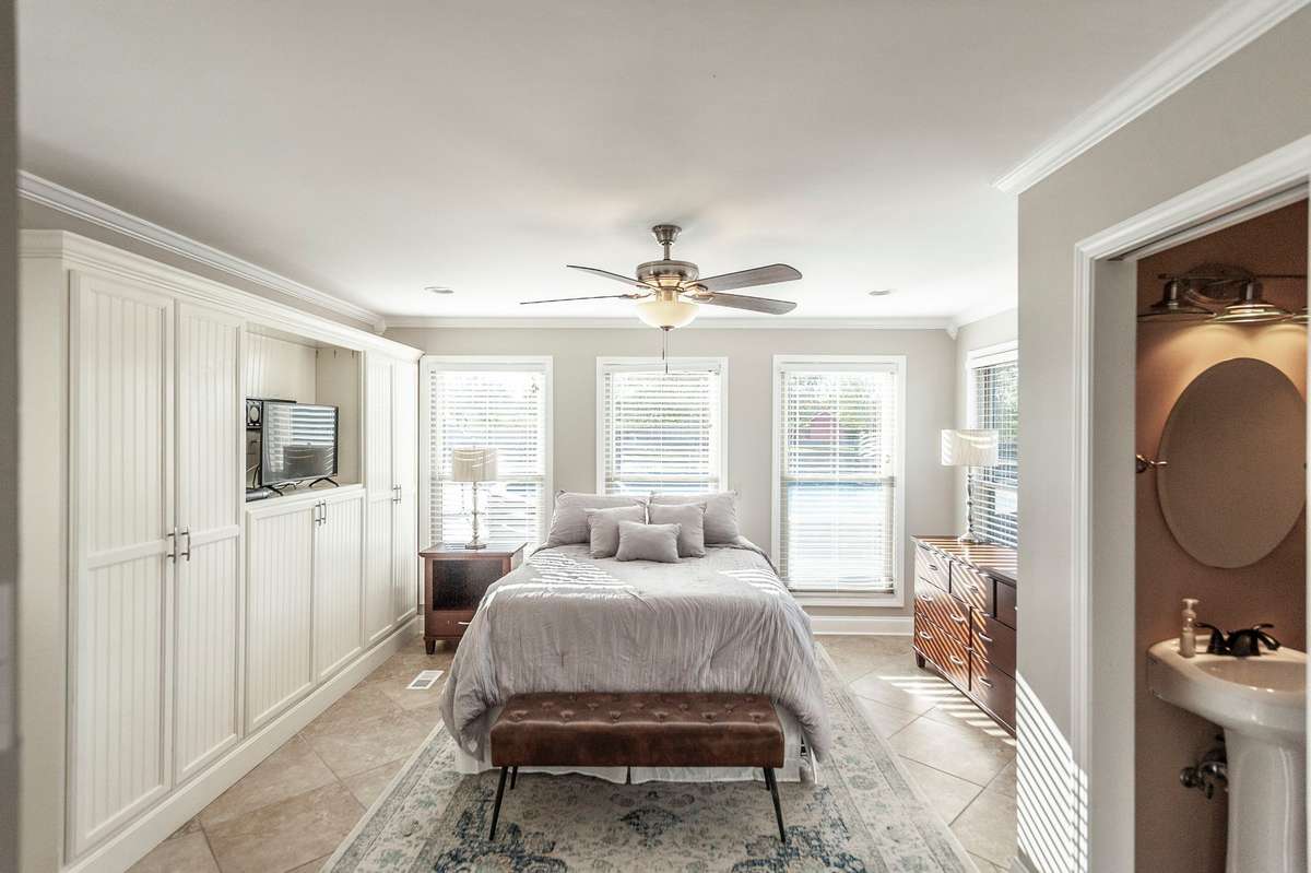 4th bedroom overlooking the pool with tiled floors, built in closets with tiled half bath!
