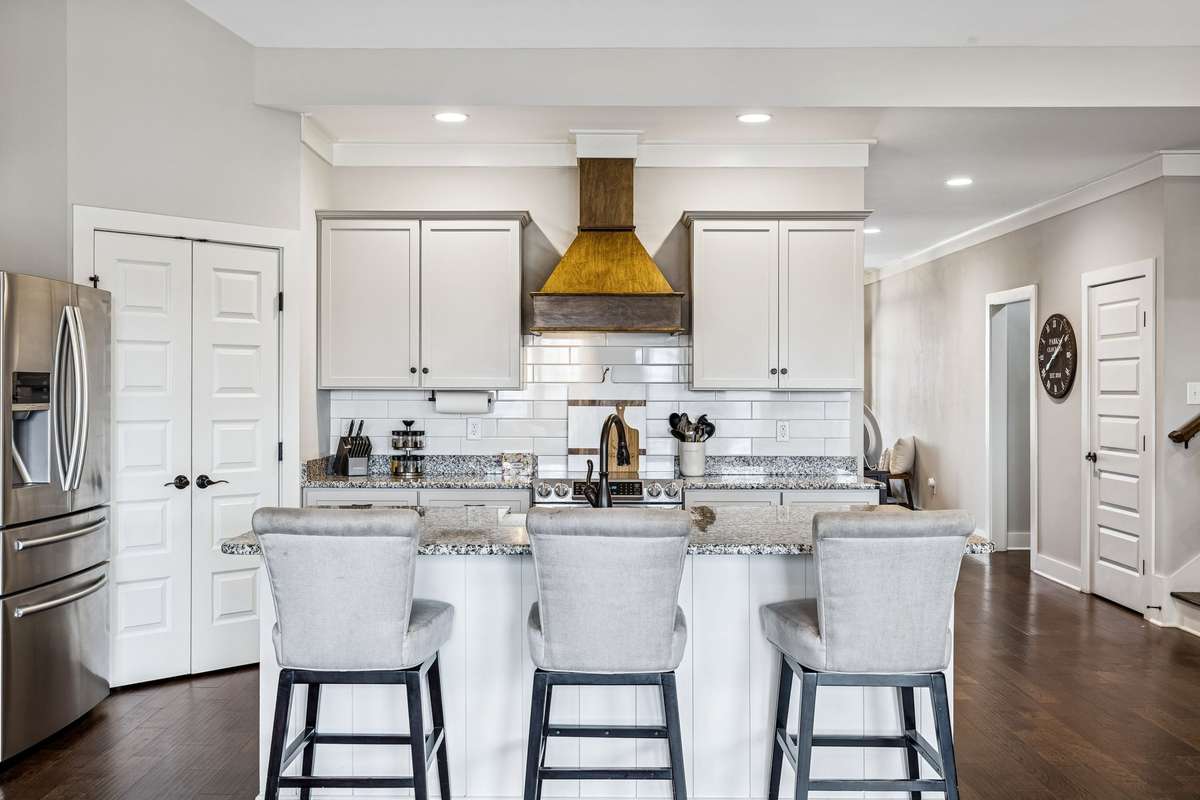 The chef in the house will love the oversized island, custom hood and abundance of cabinetry