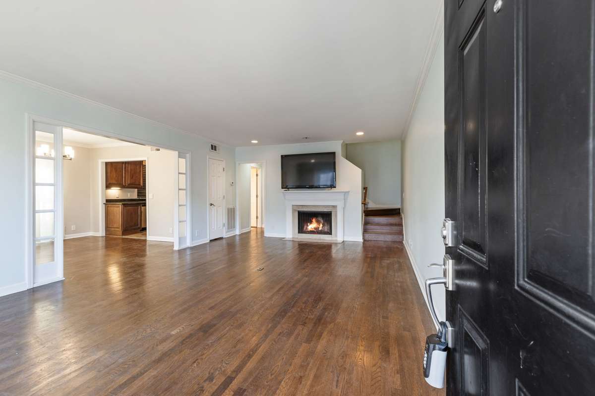 The main living area entering through the front door with fireplace