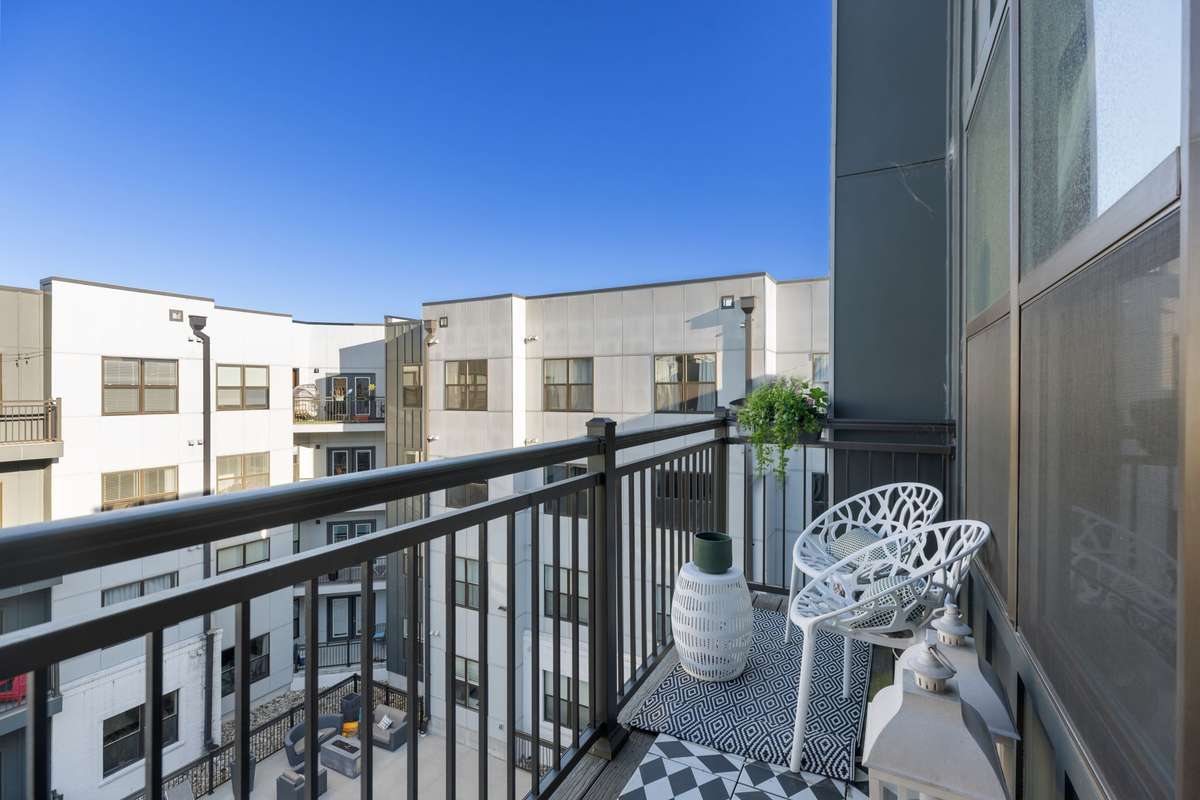 Spacious balcony with ample room for patio furniture overlooking the pool and the pool deck