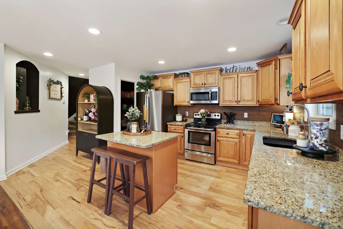 Open concept kitchen complete with island and all your stainless steel appliances - including refrigerator!