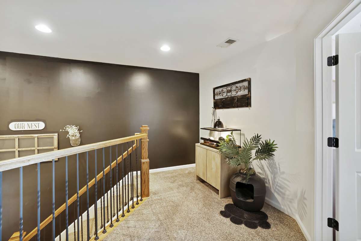 Beautiful spindles and a spacious landing at the top of the stairs leading into bedrooms 2 & 3.