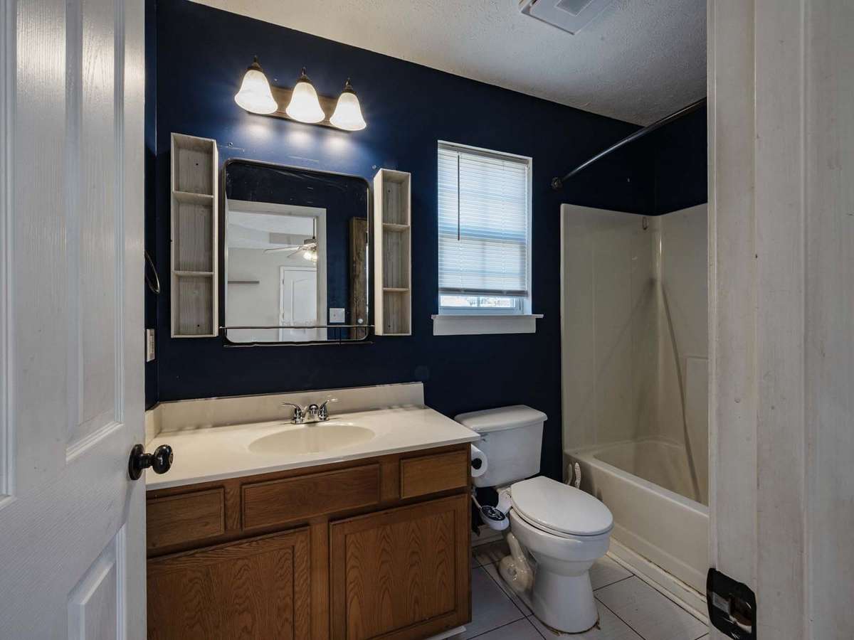 Primary bath.  Tile flooring, shower tub combo