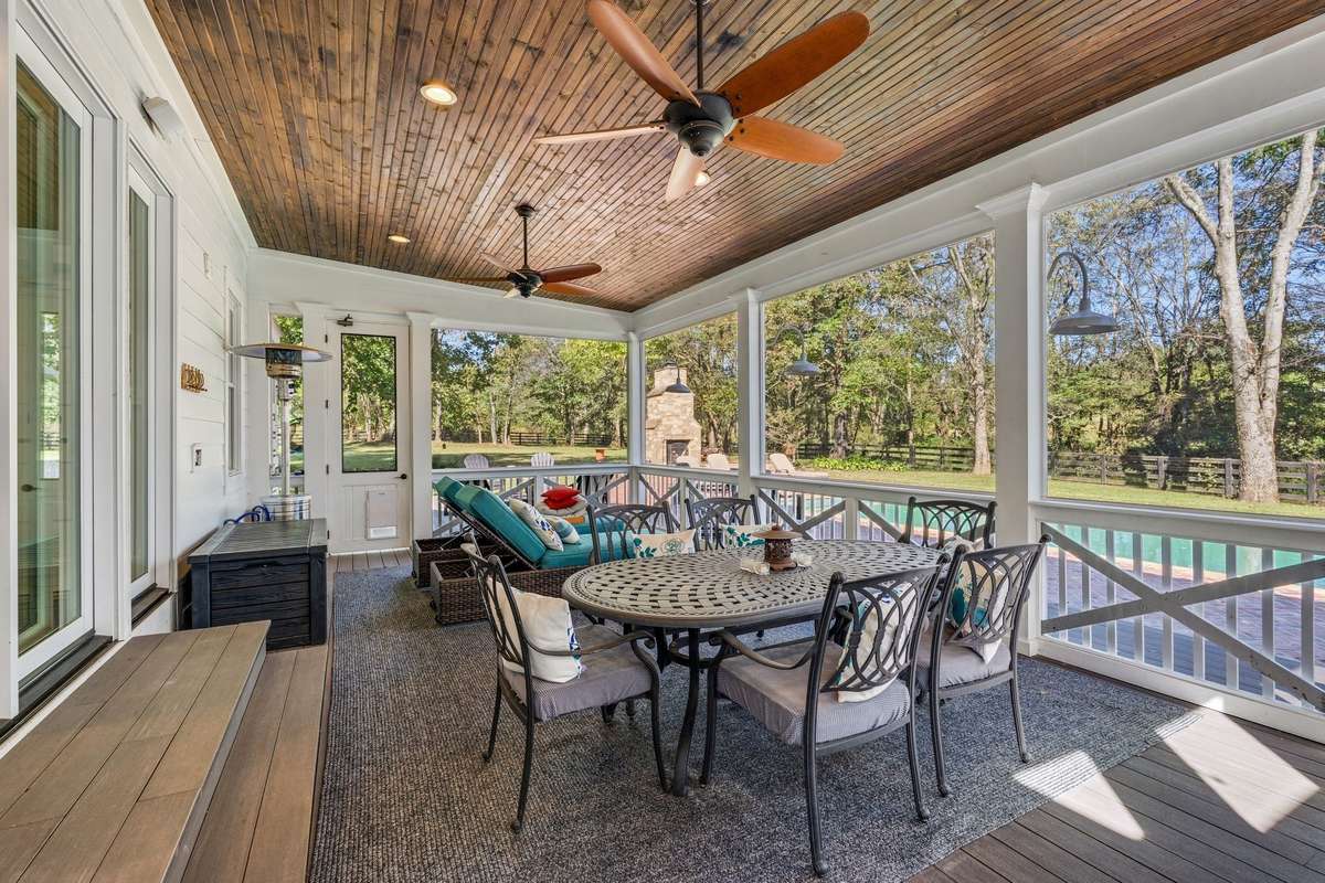 You can enjoy peace, comfort and fun on this large screened porch off of the kitchen.  It overlooks the pool and grounds.