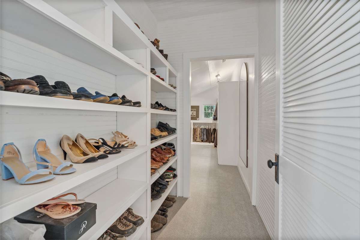 Very large walk in closet with sitting area off of bedroom four.