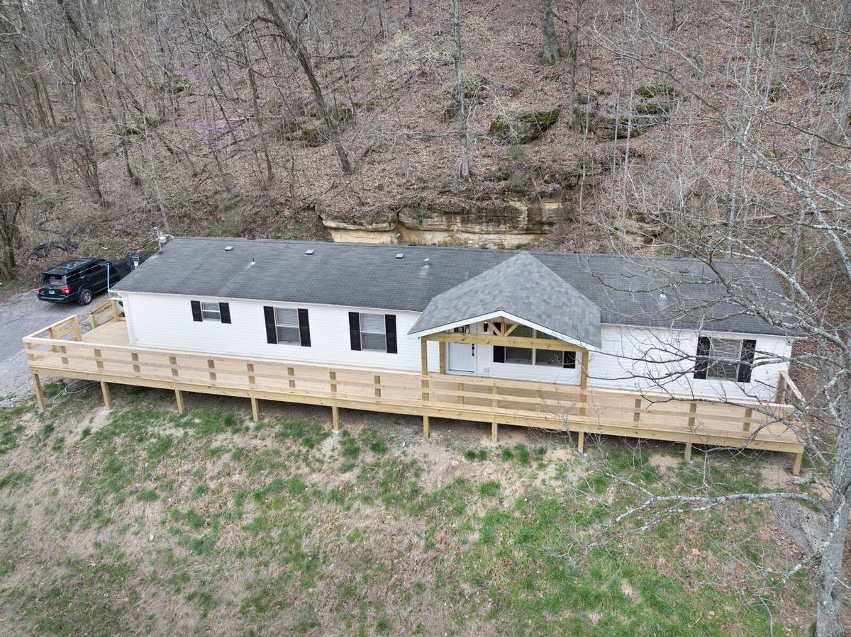 there is a new concrete parking pad next to the house at the top of the driveway (this photo was taken prior to driveway construction)