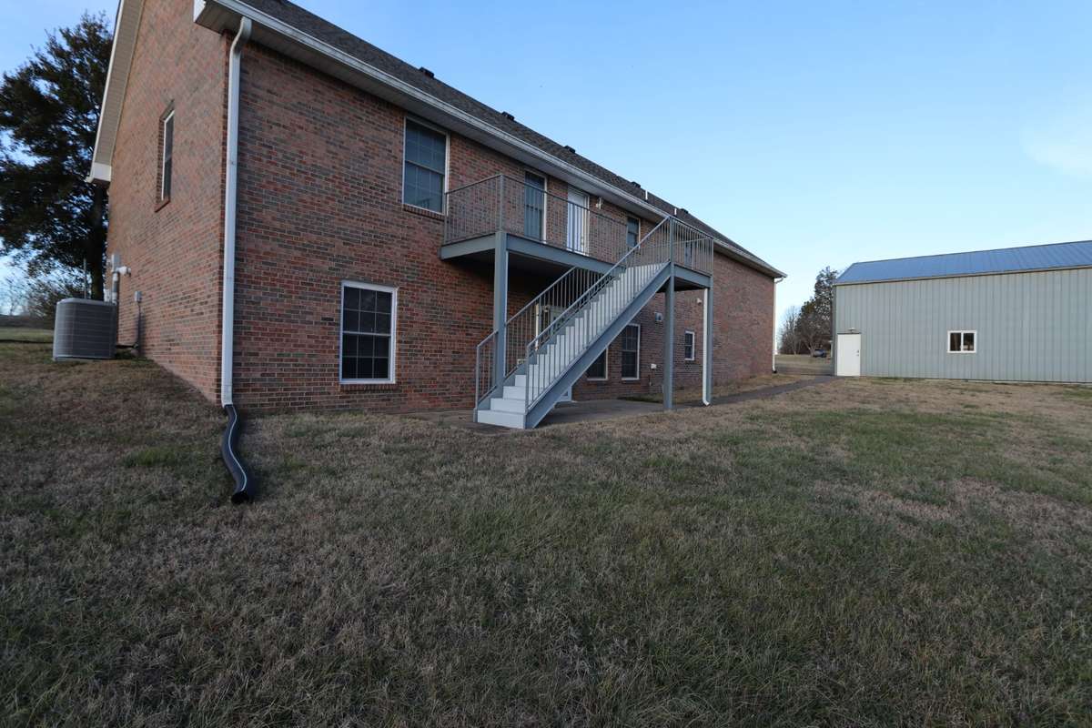 View of Deck/Stairs, Lower-Level Covered Patio and Storage Building/Shop