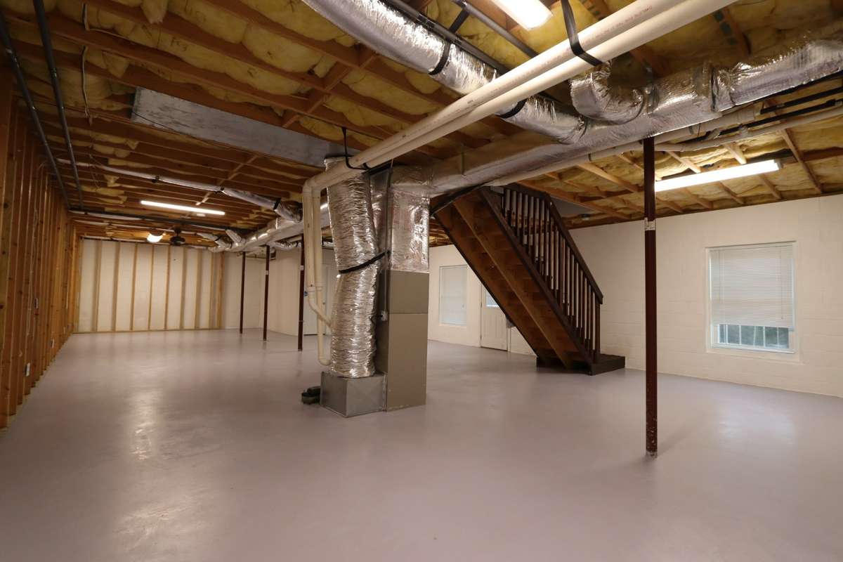 Incredible Unfinished Basement Is Truly a Canvas for Your Imagination! Easily Finish for Extra Bedrooms, Recreation Room, Home Gym, or Craft Room - The Possibilities Are Endless! Complete with Full Bathroom, Outdoor Access, & Mitsubishi Mini Split.