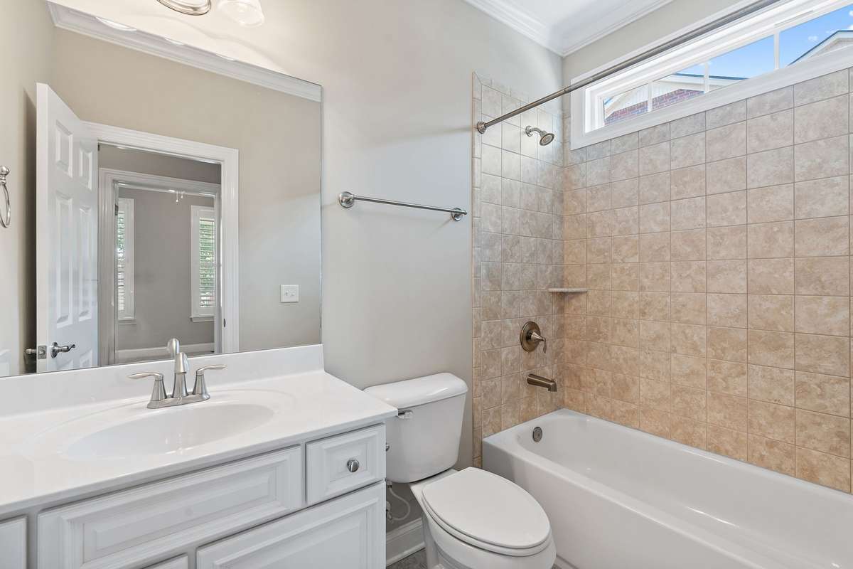 Second full bath located on the first floor, across the hall from the second bedroom